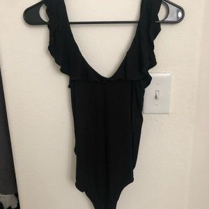 Black “off the shoulder” body suit